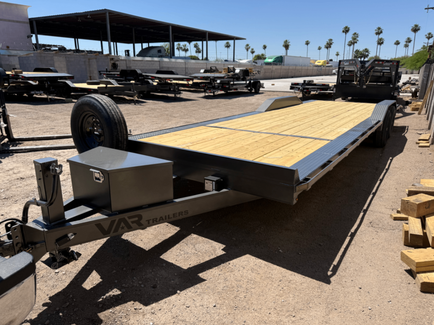 Front quarter view of the car hauler showing the tongue jack and tool box.